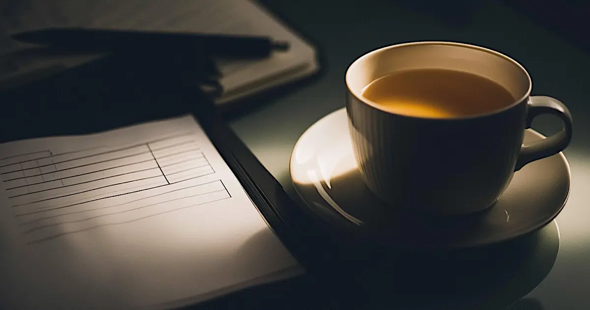 A checklist and cup of tea on a desk, representing preparation for a Mental Capacity Assessment